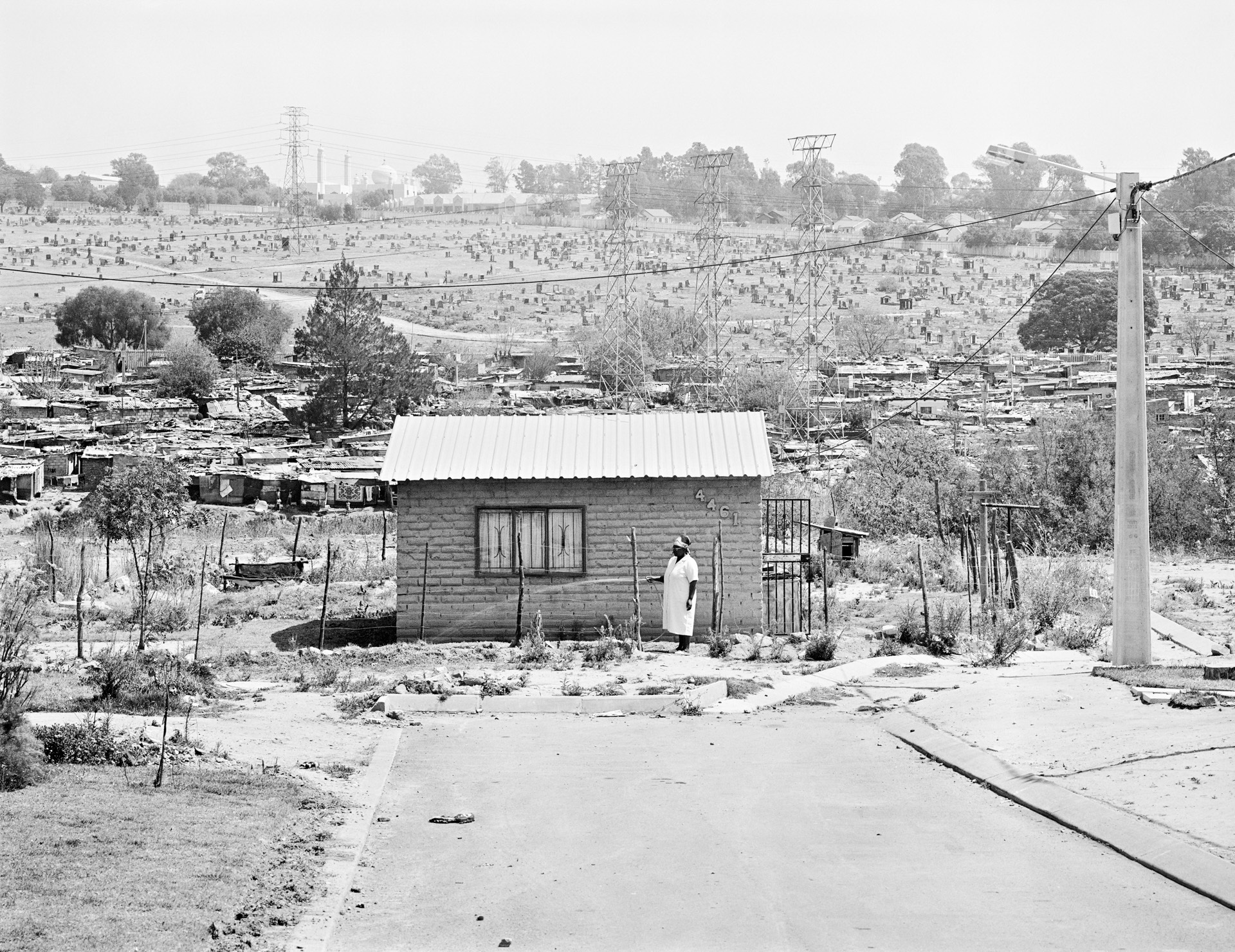 Mairiam Mazibuko waters the garden of her RDP house for