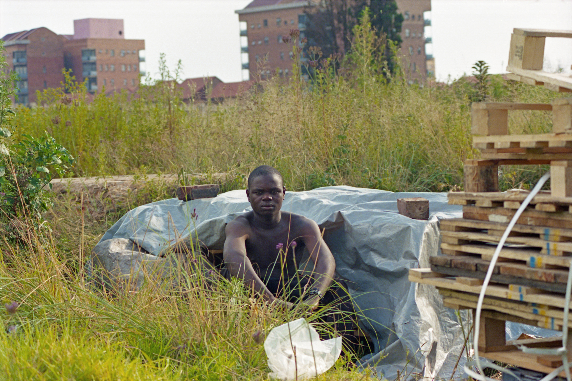 Tsvangirayi sitting by his self-made homw in Newtown before the